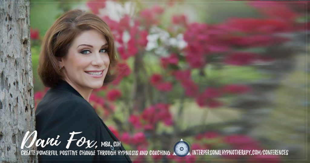 woman smiling with red flowers