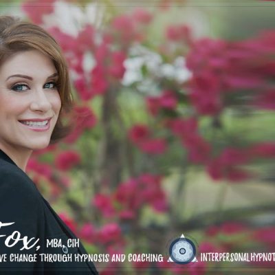 woman smiling with red flowers