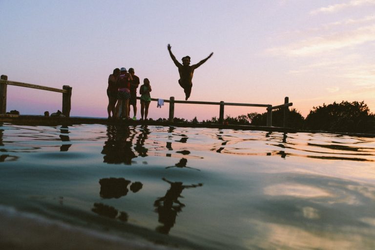 man jumping to the water